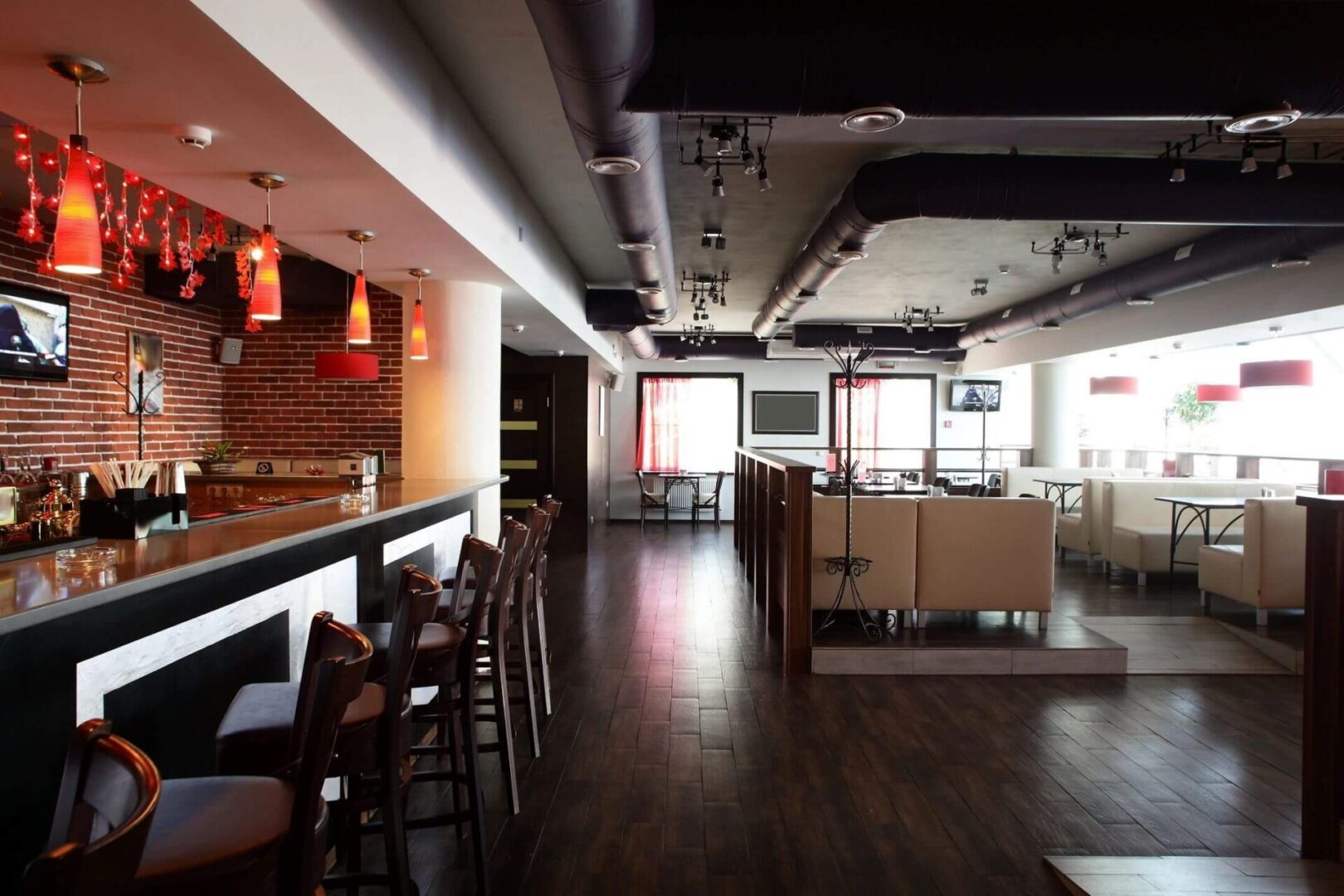 A restaurant with wooden floors and tables